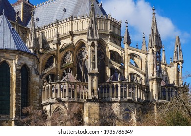 An array of flying buttresses, topped with pointed pinnacles, supporting the apse, at the back of the High Gothic Notre-Dame Cathedral of Reims, a UNESCO World Heritage Site in Northeastern France - Shutterstock ID 1935786349