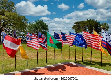 An Array Of Historic Early American Flags At A Public Park