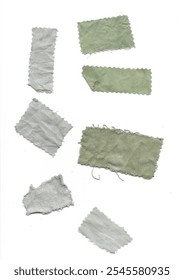 Array of light gray fabric scraps with frayed edges dyes with elderberry, presented in various shapes and sizes on a white background, ideal for textile projects.
