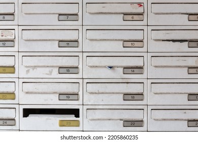 Array of numbered white metal mailboxes serving an apartment complex