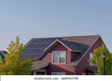 Array of photovoltaic solar panels on a roof - Shutterstock ID 1609419748