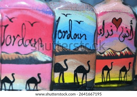An array of sand bottles souvenirs with various designs and colors at a souvenir shop in downtown market.