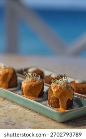 An array of small appetizers with sauce served on the marble table