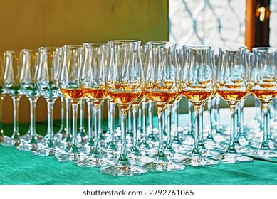 An array of wine glasses, some filled with a delicious apricot liqueur and ready for a tasting.