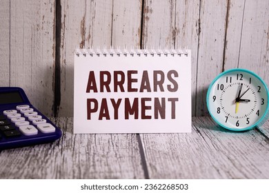 Arrears Payment write on a book isolated on Wooden Table
