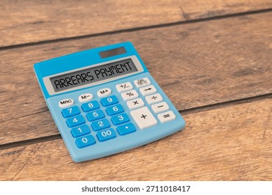 Arrears Payment write on a book isolated on Wooden Table
