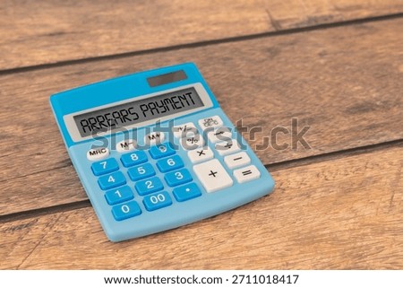 Arrears Payment write on a book isolated on Wooden Table