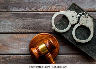 Arrest Concept. Handcuffs Near Judge Gavel On Dark Wooden Background Top-down Copy Space