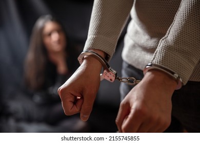 Arrest The Criminal. Handcuffed Man With Locked Hand. Law Punishment For Felony, Arrested And Cuffed For Illegal Act. Blur Safe Young Girl Dark Background.