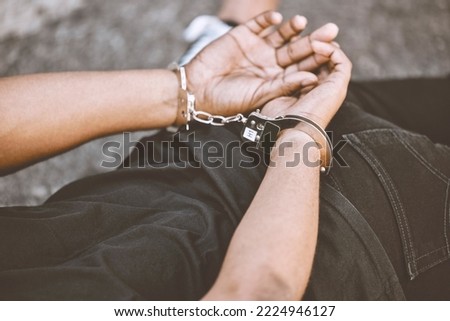 Arrest, justice and thief in handcuffs for fraud, violence and burglary after a suspected house robbery. Law, hands and gangster criminal going to jail or prison for violence and crime in Venezuela