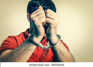 Arrested Man In Handcuffs Hidden His Face In Front Of Camera - Retro Style