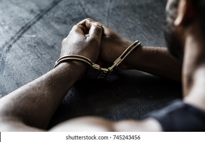 Arrested man with handcuffs on wrists