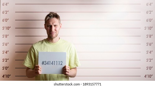 Arrested Prisoner Young Man Holding A Placecard In Front Of The Height Chart 