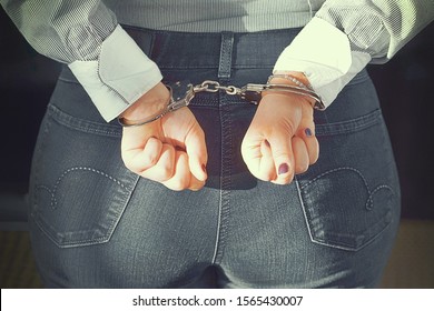 Arrested Woman Handcuffed Hands At The Back. Prisoner Or Arrested Terrorist, Close-up Of Hands In Handcuffs