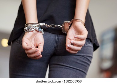 Arrested Young Girl Handcuffed Hands At The Back. Prisoner Or Arrested Terrorist, Hacker, Bribetaker, Close-up Of Hands In Handcuff.