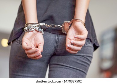 Arrested Young Girl Handcuffed Hands At The Back. Prisoner Or Arrested Terrorist, Hacker, Bribetaker, Close-up Of Hands In Handcuff.