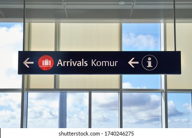 Arrivals sign at an airport in English and Icelandic. Komur translates to arrivals.