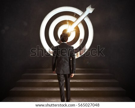 Arrive at a goal of success. Businessman climbing the stairs up to a target.. 3D Rendering