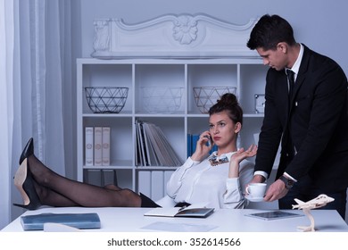 Arrogant Business Woman With Legs On The Desk