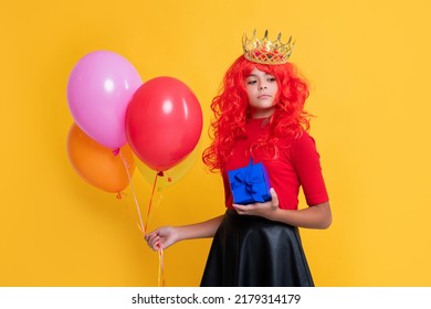 Arrogant Child In Crown With Gift Box And Party Balloon On Yellow Background