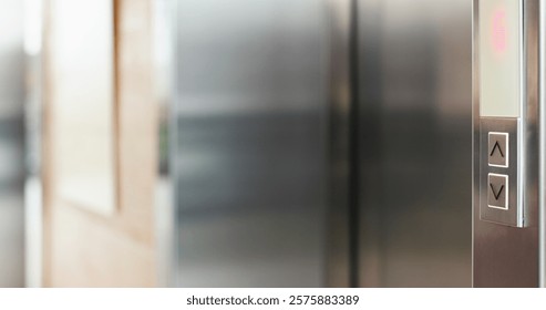 Arrow, button and elevator in office building for up or down direction for arrival at floor of choice. Press, push and select with electronic lift service in corporate workplace for convenience