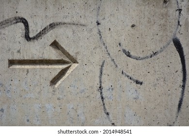 Arrow Carved In A Grey Concrete Roadblock