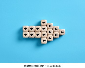 Arrow icon made of wooden cubes with little arrow icons pointing opposite direction. Resistance to change in business concept. - Shutterstock ID 2169388133