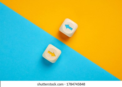 Arrow icons in contrast on wooden cubes moving towards opposite directions. Competition, diversity, opposition or confrontation concept.  - Shutterstock ID 1784745848