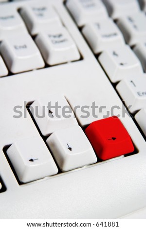 Arrow keys on a desktop computer keyboard with the right arrow red