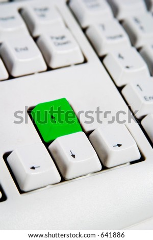 Arrow keys on a desktop computer keyboard with the up arrow green