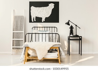 Arrow And Lamp On Nightstand Next To Bed In Black And White Simple Bedroom Interior With Sheep Poster