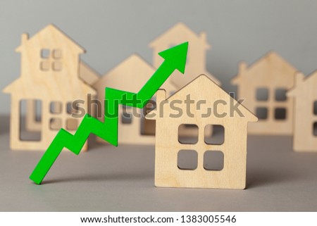 Up arrow and many houses. Growth in real estate prices market. Buying and selling house.