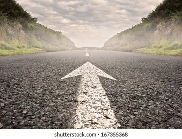 arrow on asphalt road to the horizon - Shutterstock ID 167355368