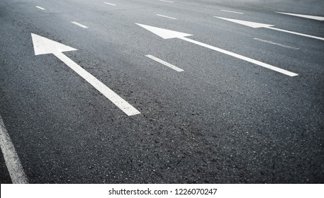 Arrow On The Road And White Color Pedestrian Pathway On A Street Crossing 