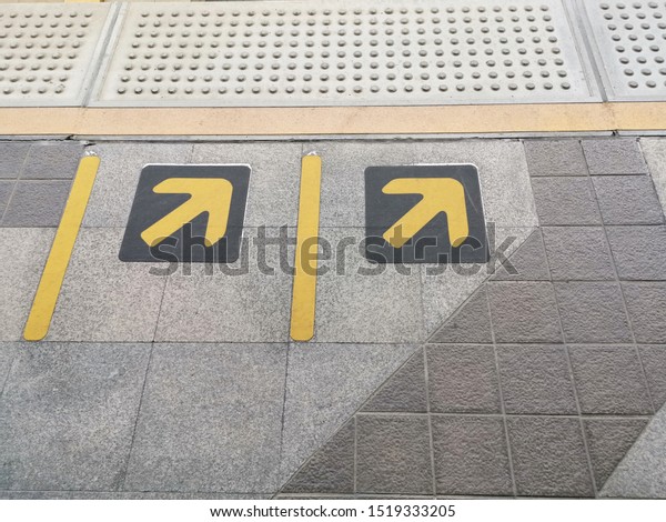 Arrow Sign icon on foot path for Handicap person\
in Train Subway Station