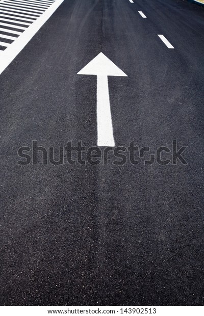 Arrow sign as road\
markings on a street