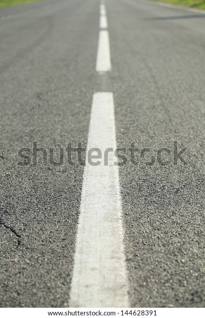 Arrow signs\
as road markings on suburban\
driveway