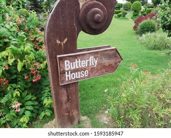 Arrow Towards Butterfly Enclosure In A Beautiful Garden 