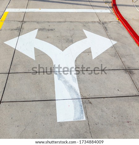 arrows and lines on the asphalt to indicate the direction of driving