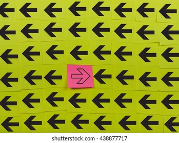 Arrows. Opposite concept. Background of green sticky notes. 