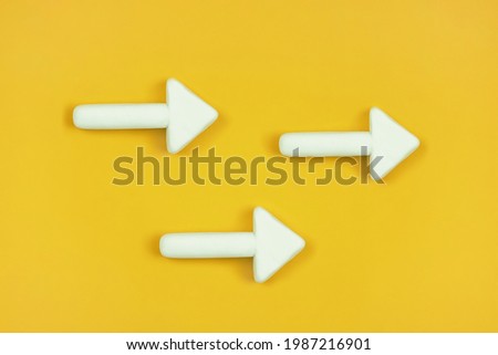 Arrows pointing right side. 3D mockup, white sign pointing direction on orange background. Right way concept.