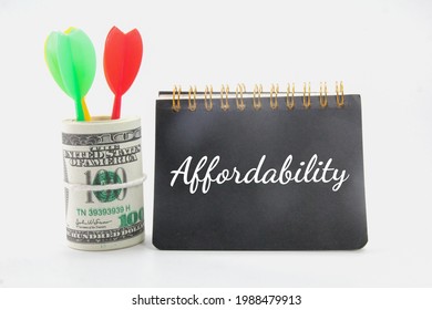 arrows, a roll of paper money, a notebook and the word affordability