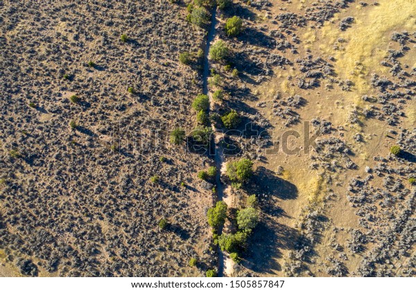 An\
arroyo, or wash, cuts through the high Utah\
desert.