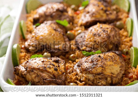 Arroz con pollo, roasted chicken with rice in a baking dish