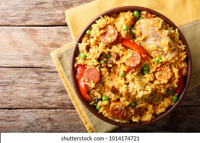 Arroz Valenciana with rice, meat, sausage, raisins, vegetables and spices close up in a bowl on the table. horizontal top view from above
 - Powered by Shutterstock