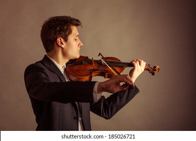 Art And Artist. Young Elegant Man Violinist Fiddler Playing Violin On Brown. Classical Music. Studio Shot.