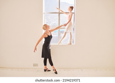 Art, Ballet And Dance Teacher With Girl Ballerina Practicing Posture By A Window In A Studio. Creative Child Dancer Training With An Instructor For A Recital Concert. Young Student Dancing With