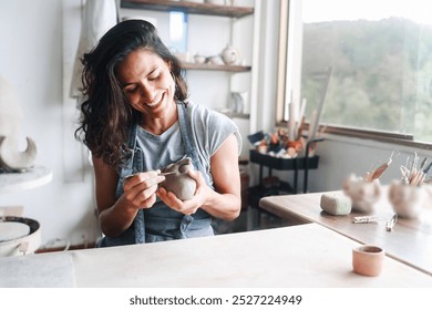 Art business, Artist work with ceramic at clay pottery workshop studio. Woman doing sculpture. Small business, handmade creativity concept - Powered by Shutterstock