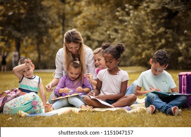 Art Class At Nature. Large Group Of Children And Teacher. 