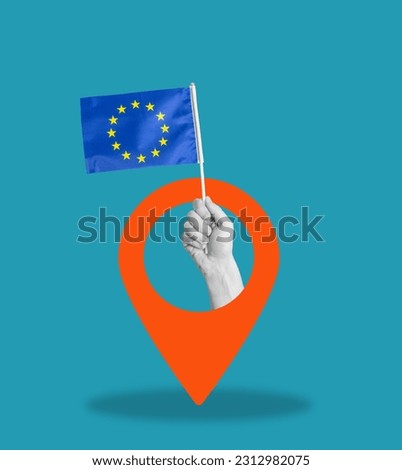 Art collage, collage of a hand holding the flag of the European Union, navigation icon on a blue background. Concept of the direction of the EU on a blue shabby background.